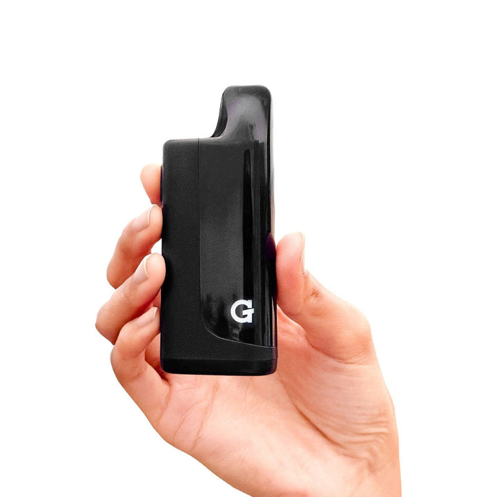 G Pen Hydout negro sostenido en la mano, batería para cartuchos 510 con tapa magnética