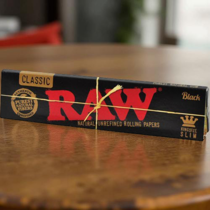Librito RAW Black King Size Slim frontal sobre mesa, edicion ultra fina